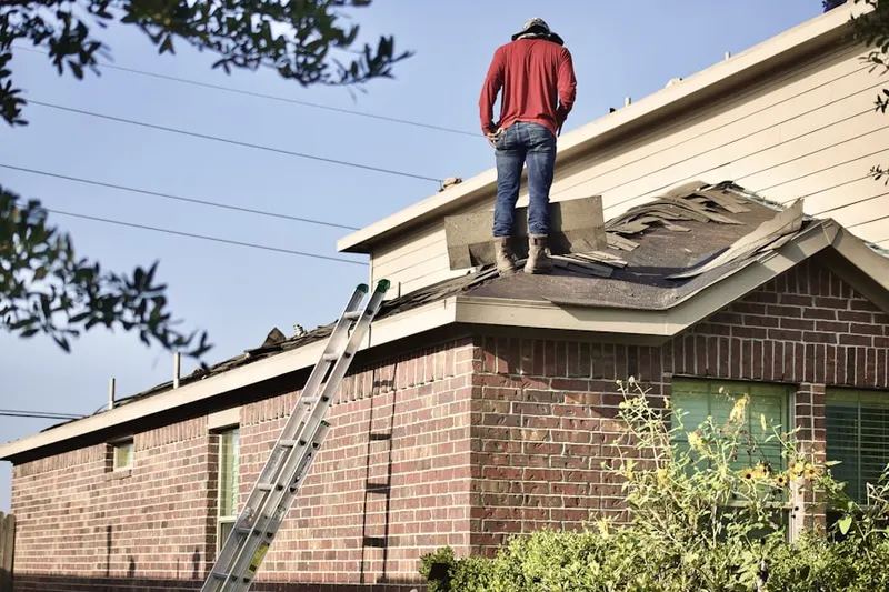 Professional roofer working on a residential roof in Marengo
